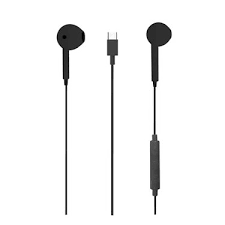A variety of wired headphones displayed on a table.